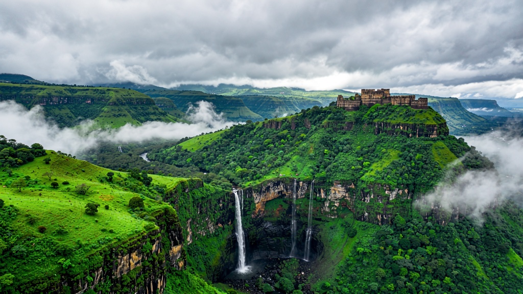 Monsoon valley of the Sahyadri Western Ghats near Lonavla, with mist, waterfalls and a distant hill fort