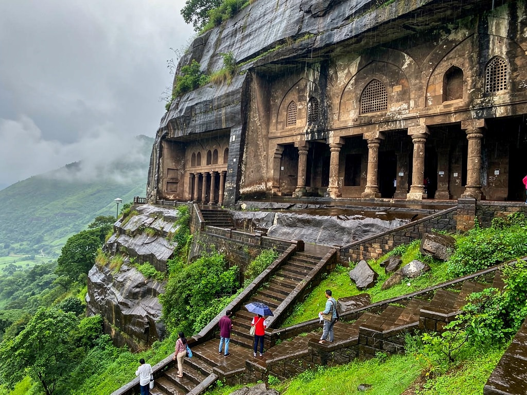 The rock-cut entrances of the Bhaja Caves on a cliff near Lonavla
