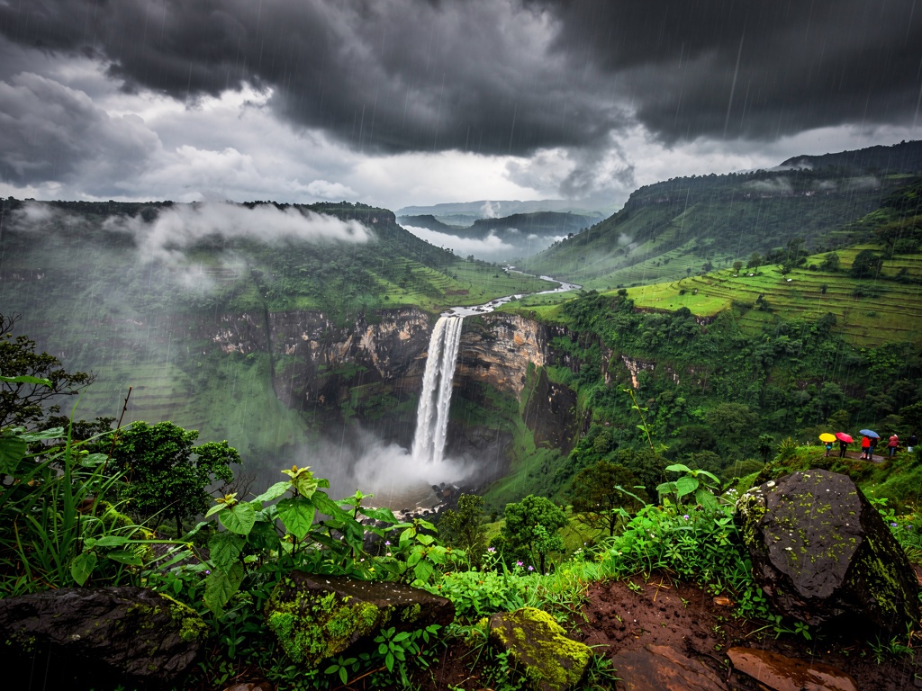 Heavy monsoon rain over a lush green valley near Lonavla