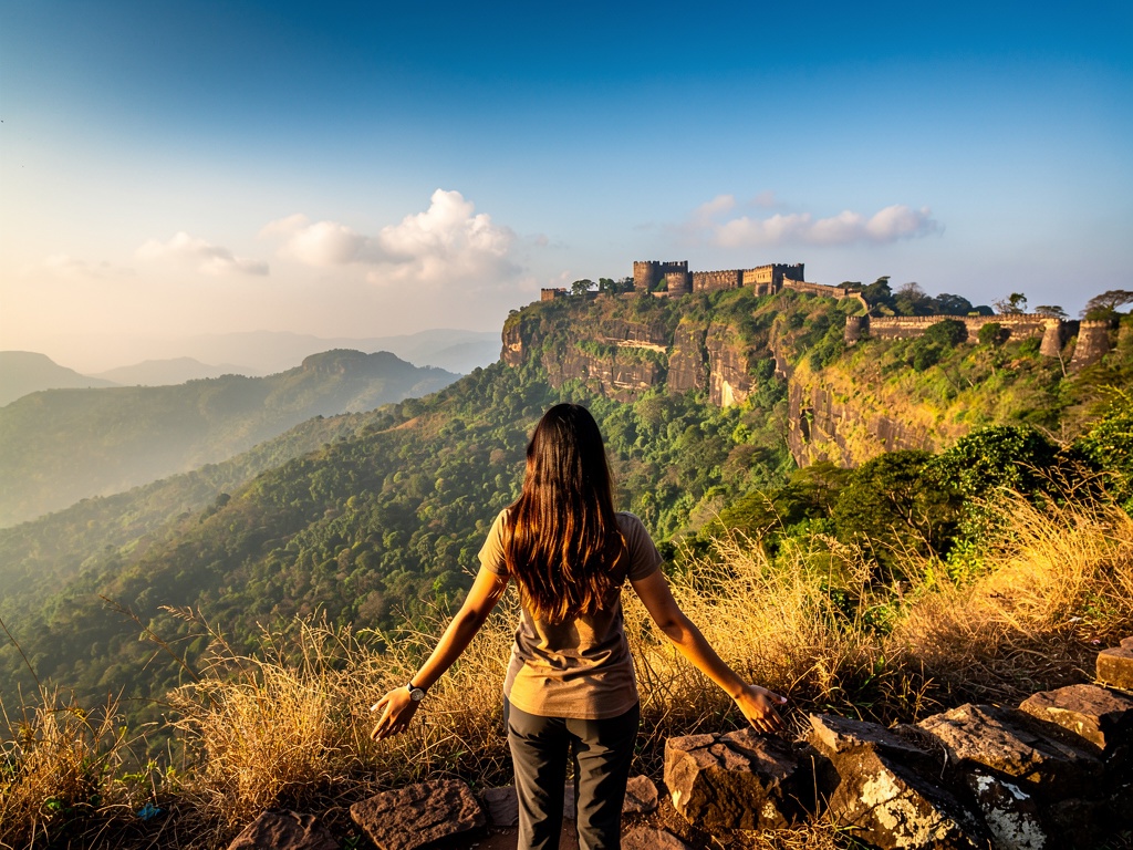Clear winter morning with golden light over green hills near Lonavla